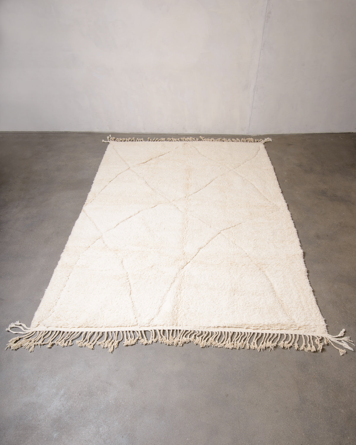 Modern, designer, handcrafted Berber rug from Morocco. Beniourain carpet with minimalist design, natural wool pile and a fluffy texture.
